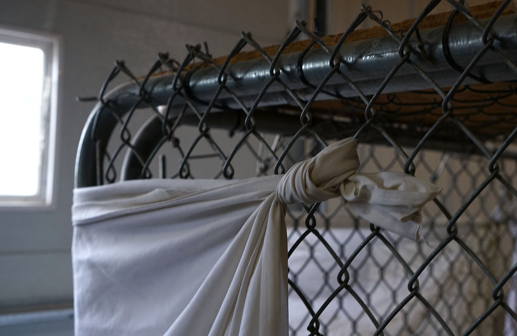 A sheet tied to a kennel is used to block firework light Wednesday